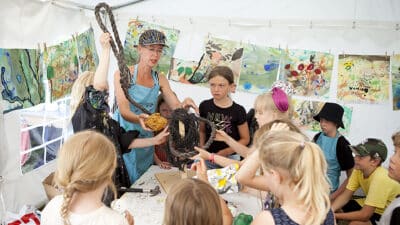 Nanna with children at one of the workshops making a giant sculpture out of waste