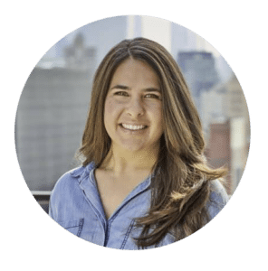 A smiling woman with long hair and a blue shirt