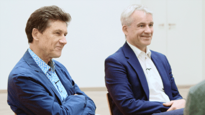 Two people seated, smiling